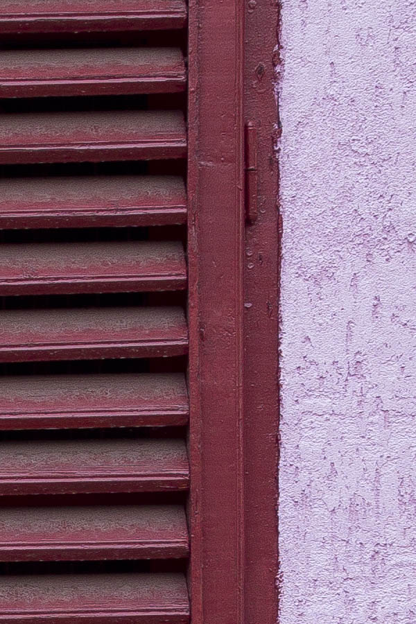 Photo 25782: Window with red, formed shutters in a pink wall
