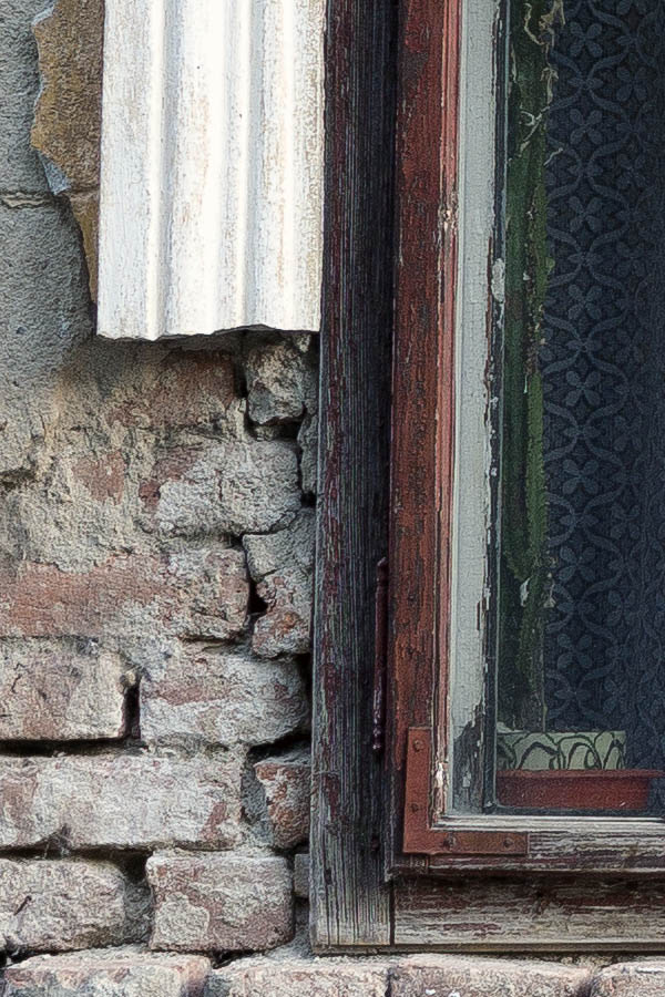 Photo 25812: Worn facade with two brown window with four frames each