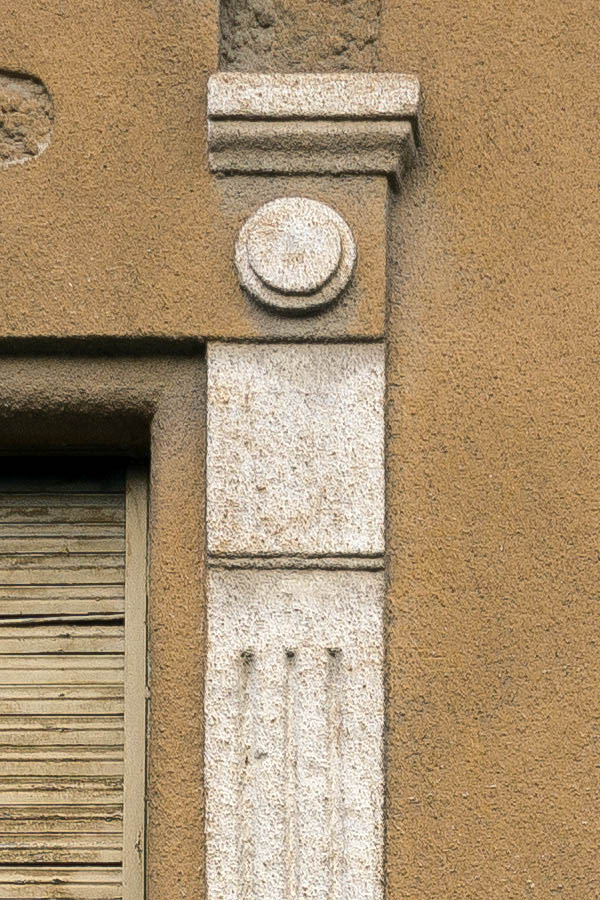 Photo 25834: Facade with two windows covered by worn, yellow security shutters