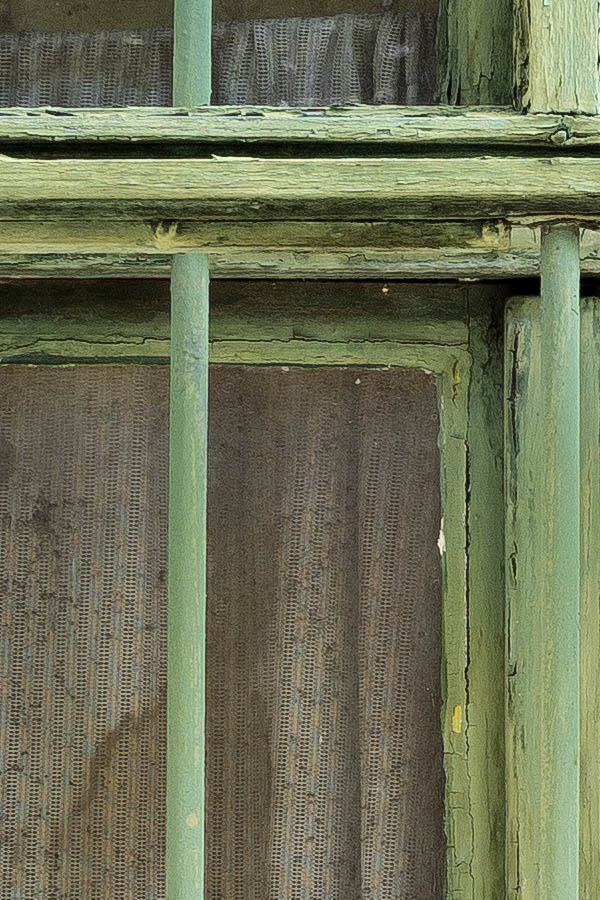 Photo 25995: Worn, barred, green window with four frames and six panes