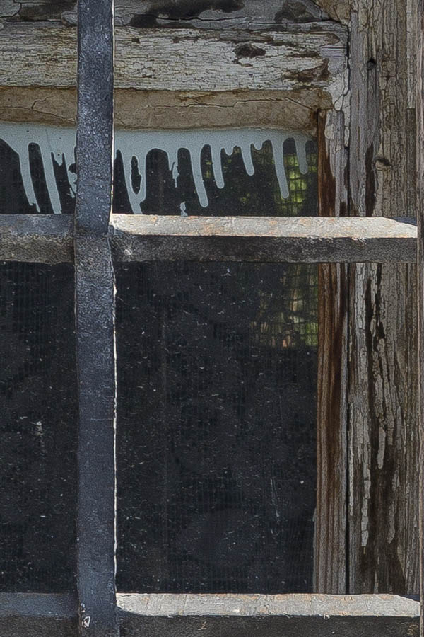 Photo 26000: Little, worn, barred, white and unpainted window with four panes