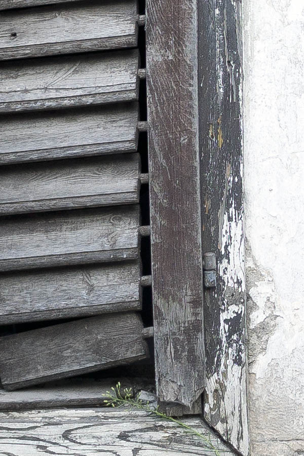 Photo 26174: Facade with two decayed, brown shutters in a decayed, grey, plastered wall