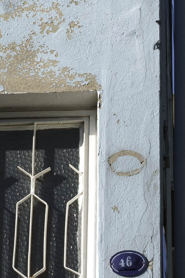 Photo 26635: Narrow, light blue facade with white, latticed door