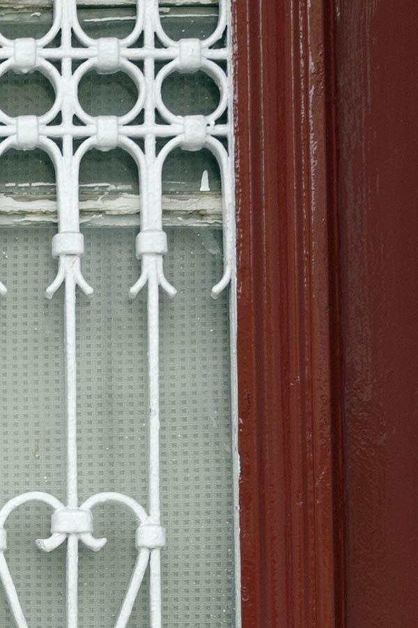Photo 26719: Narrow, dark red, panelled double door with white lattice