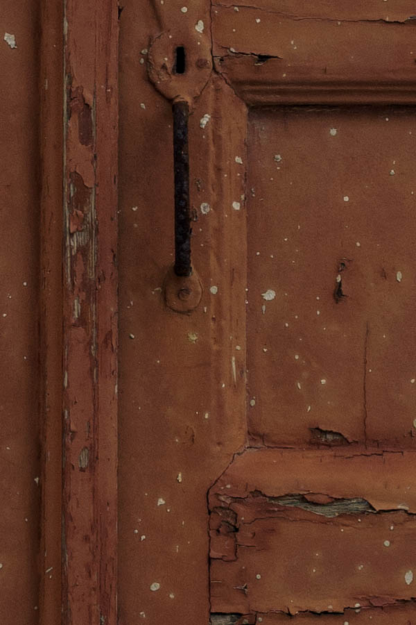 Photo 26833: Worn, brown, panelled double door in a white frame