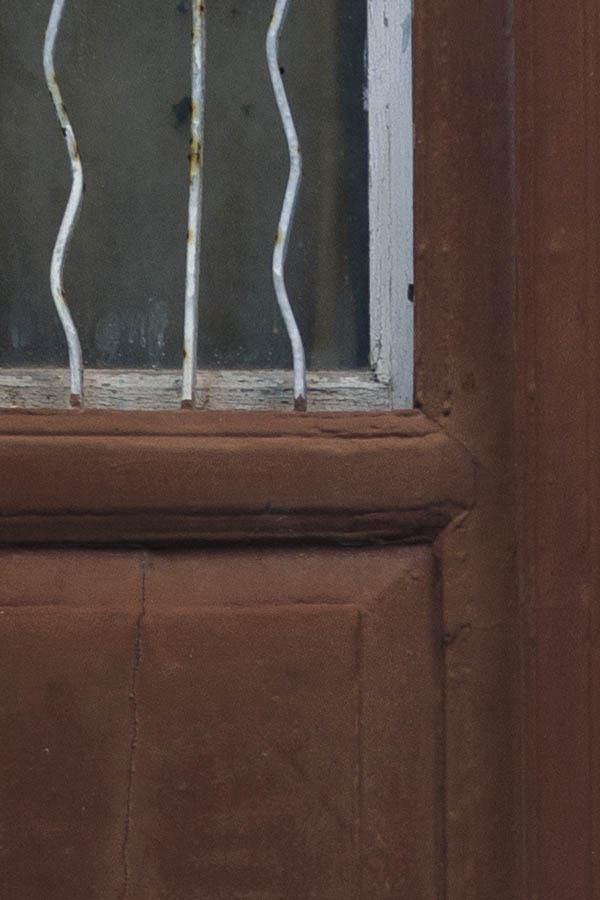 Photo 26865: Narrow, brown, panelled double door with white lattice in a white frame