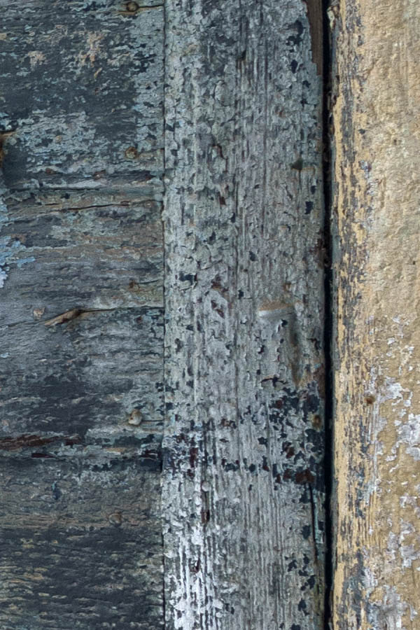 Photo 26871: Decayed, narrow, blue and teal double door of boards in a yellow frame