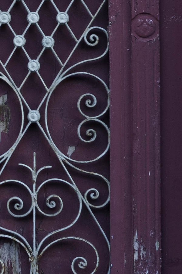 Photo 26938: Large, worn, panelled, carved, purple double door with fan light and lattice