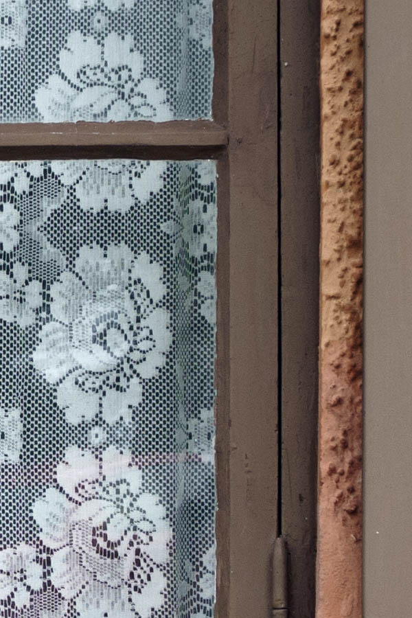 Photo 27117: Worn, brown window with two panes and four frames. Shutters.