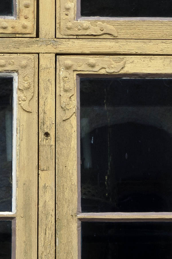 Photo 27219: Yellow window with four frames, 20 panes and shutters.