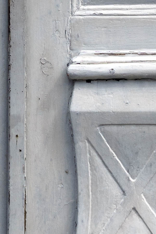 Photo 27294: Worn, light grey, panelled, carved double door with top window