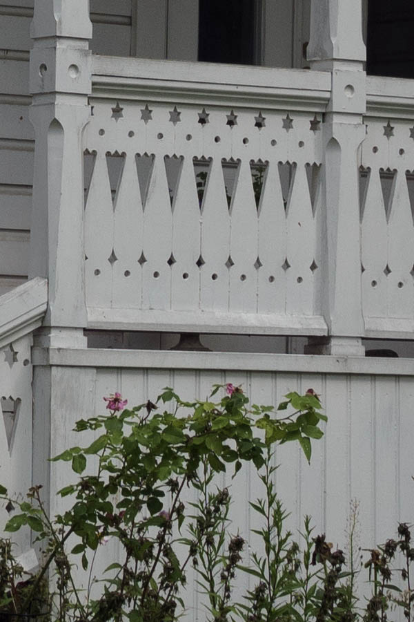 Photo 27364: Facade of white, wooden villa with carved veranda