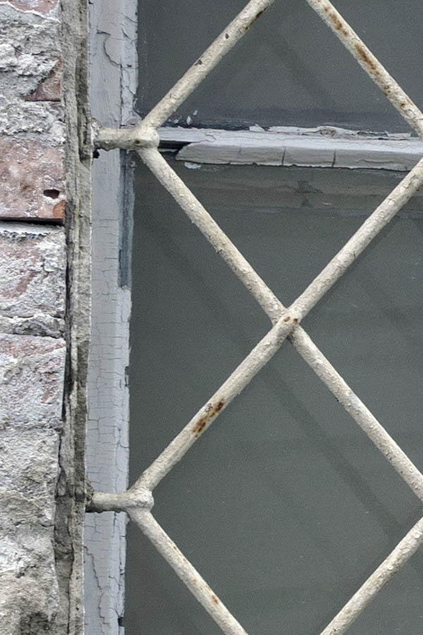Photo 27374: Worn, white, latticed window with two frames and six panes