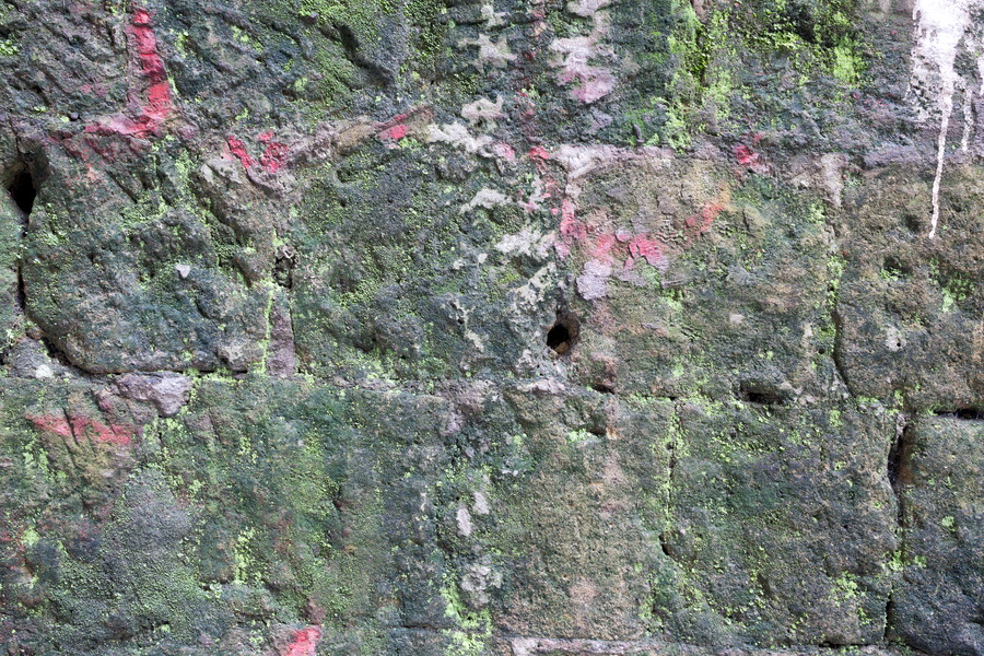 Photo 23932: Worn stone wall with red and green patterns
