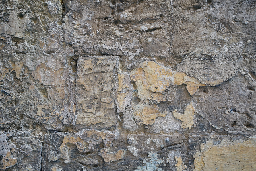 Photo 24265: Worn, grey and yellow sandstone wall