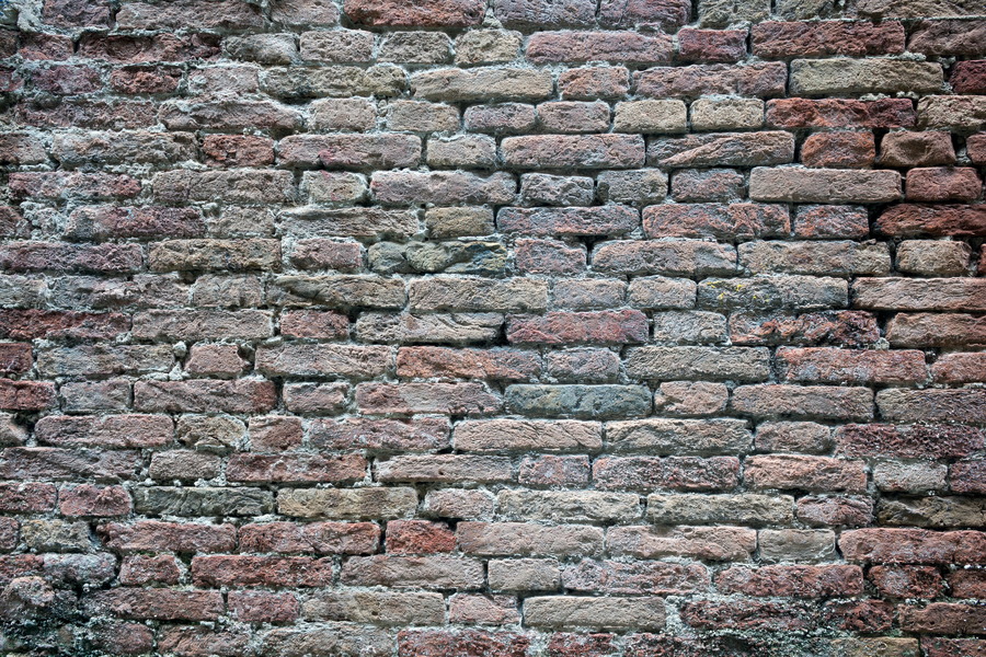 Photo 24787: Worn brick wall in red, yellow and blue colours