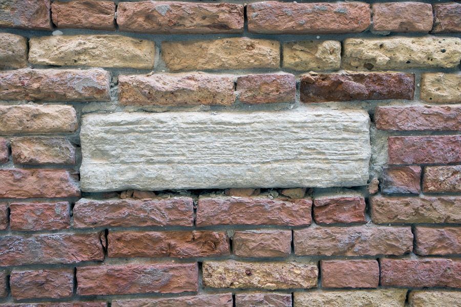 Photo 24867: Decayed brick wall in red, yellow and brown with white sandstone