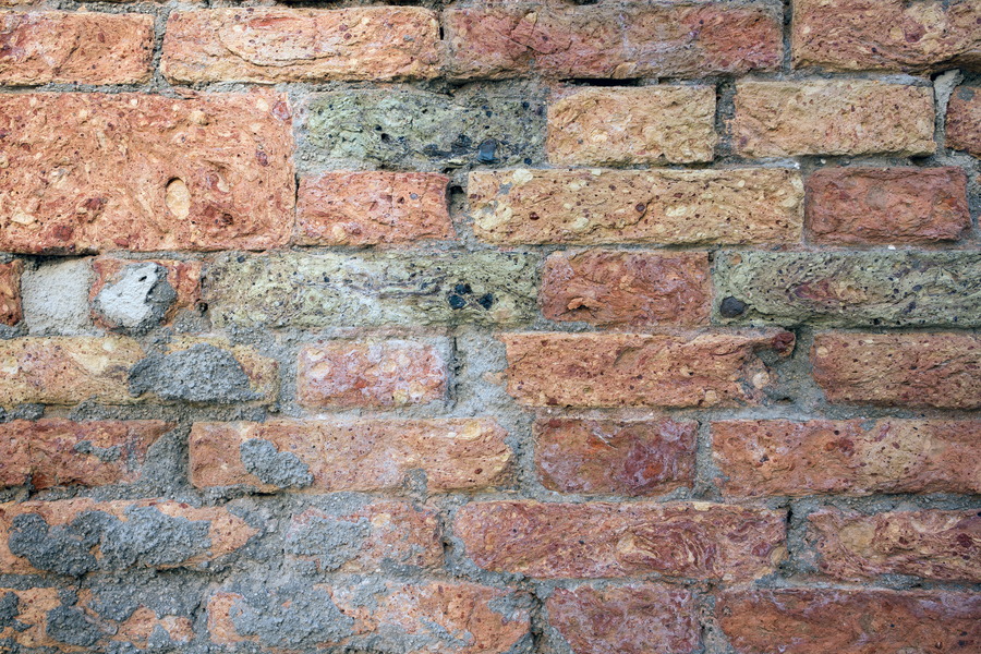 Photo 24876: Worn brick wall in yellow, red and grey colours