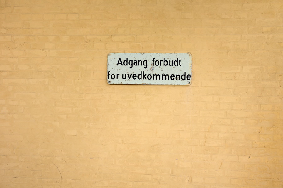 Photo 25117: Yellow, plastered brick wall with sign 