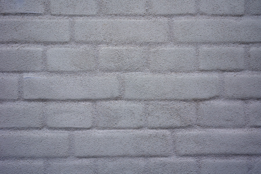 Photo 25246: Grey, plastered brick wall. Well maintained.