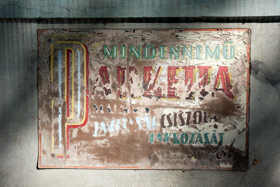 Photo 25509: Grey, plastered wall with unreadable poster in Hungarian