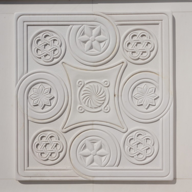 Photo 26390: New, white relief of plaster with various symbols