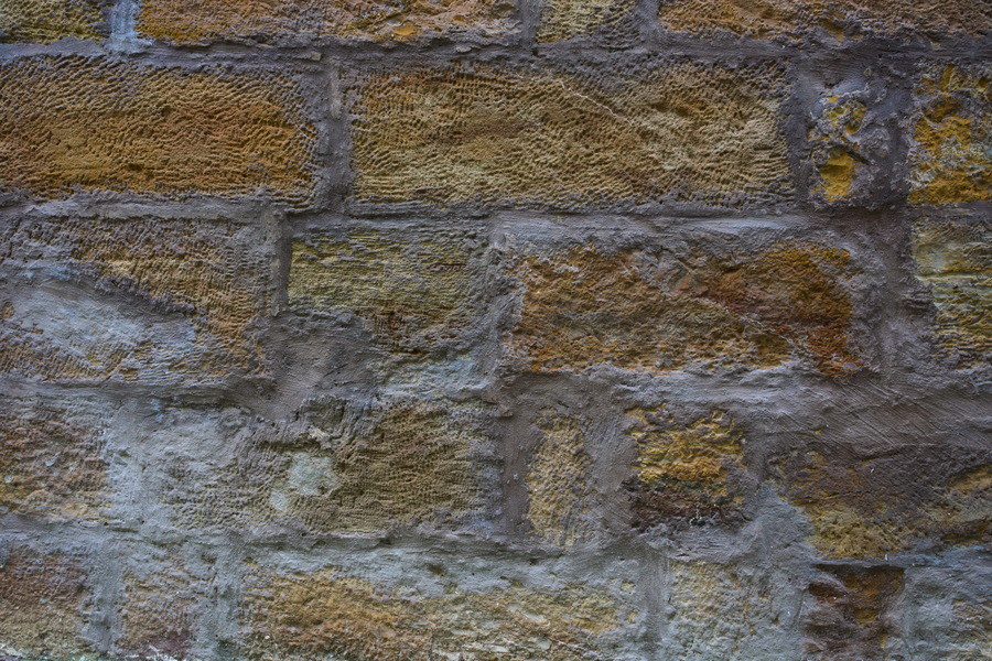 Photo 27438: Worn, yellow brick wall