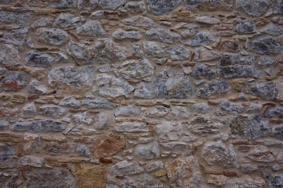 Photo 27460: Stone wall with blue and light yellow stones. Well maintained.
