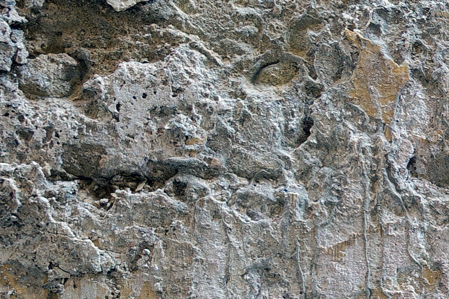 Photo 24265: Worn, grey and yellow sandstone wall
