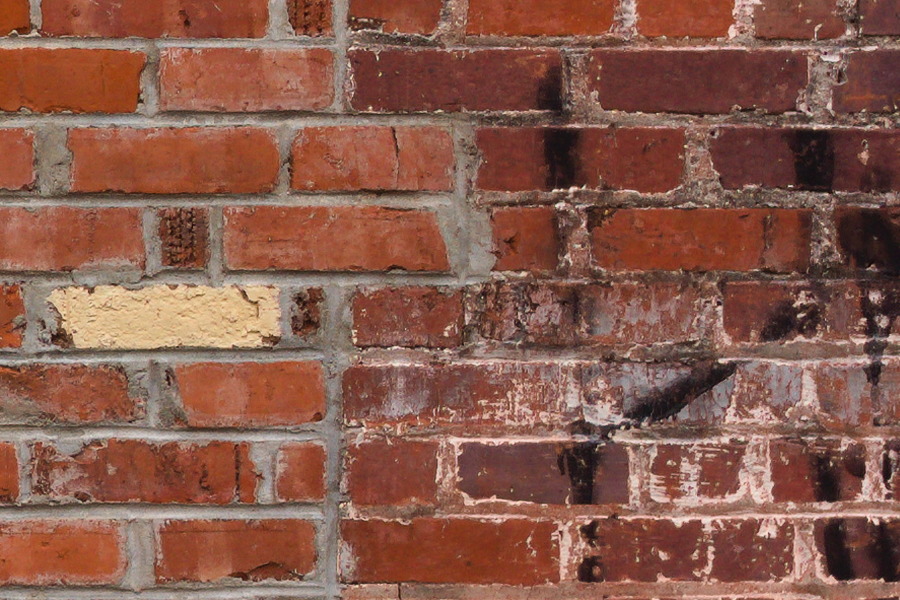 Photo 27517: Worn, red brick wall with drainpipe